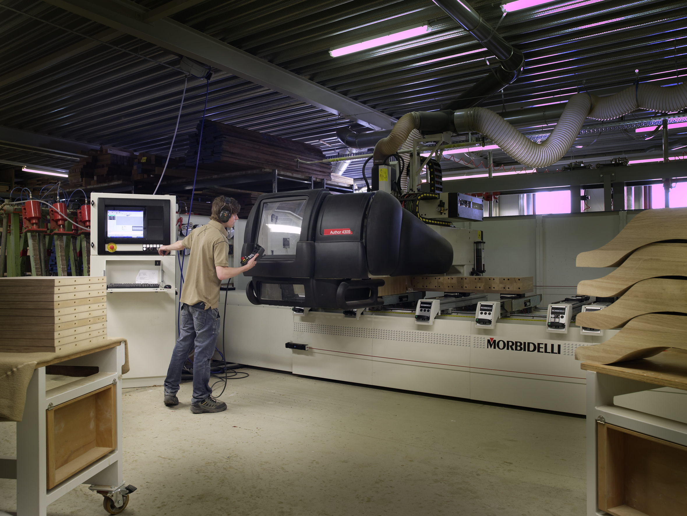 Operator at an industrial CNC woodworking machine