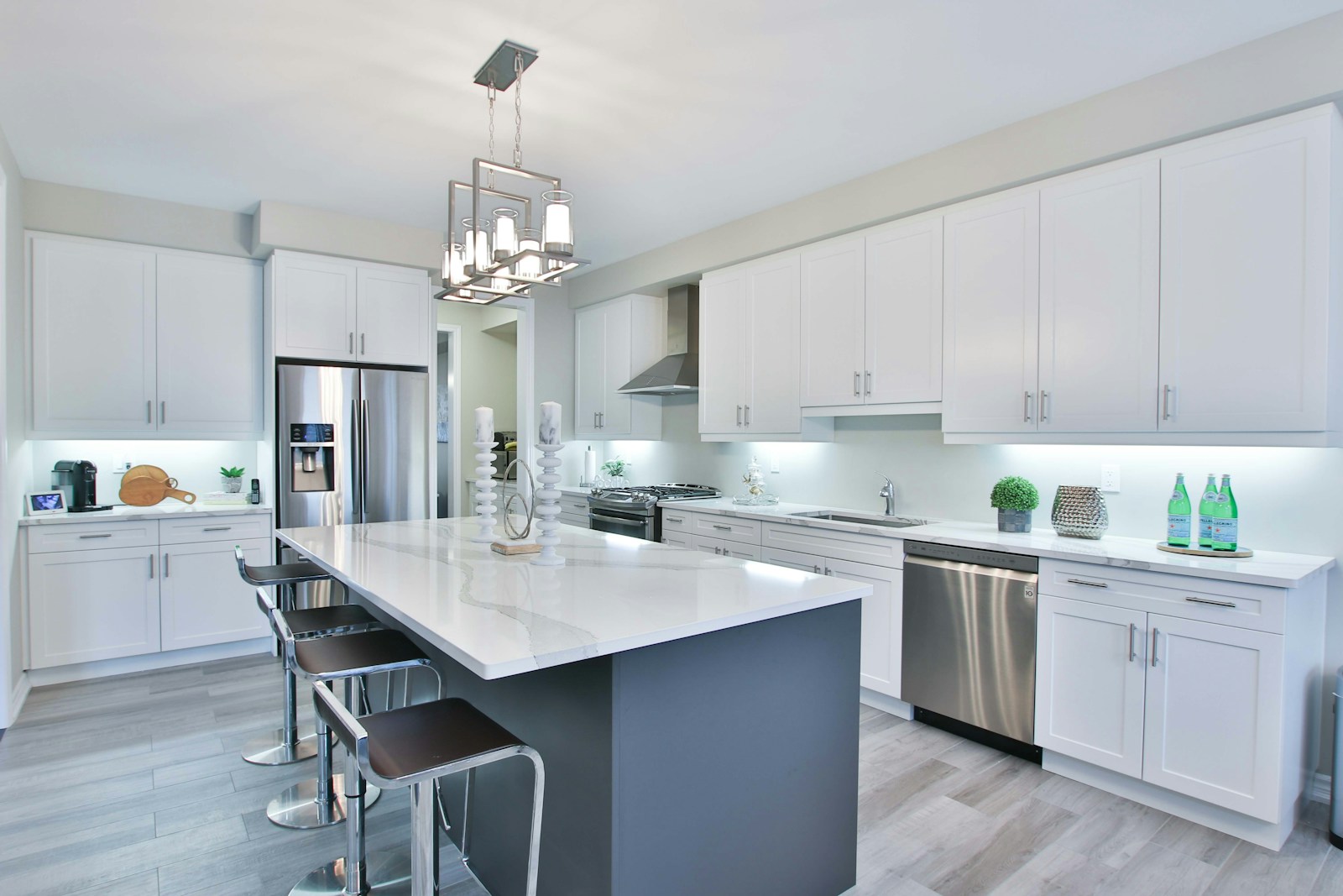 White fitted kitchen with an island and full-height cabinets
